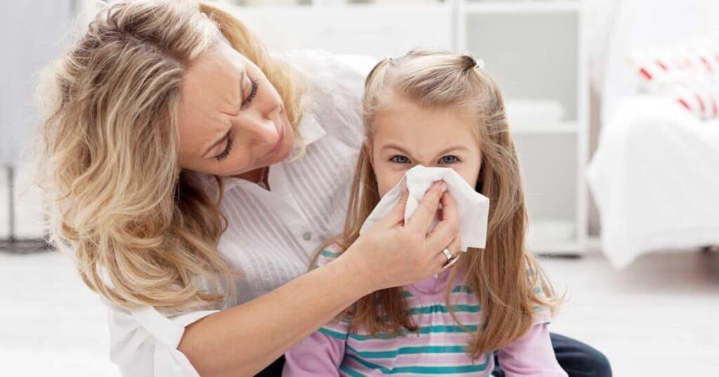 mother with young girl having allergy symptoms 1080x567