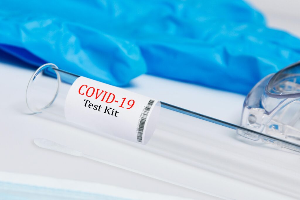 High-quality image of a COVID-19 test kit showing swab and test tube.